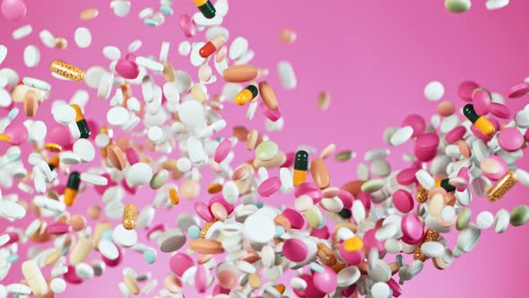 Super Slow Motion Shot of Flying Colorful Pills on Pink Background at 1000Fps