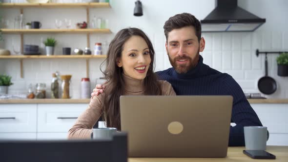 Happy Couple Making Videocall Using Laptop Online Chat Application at Home