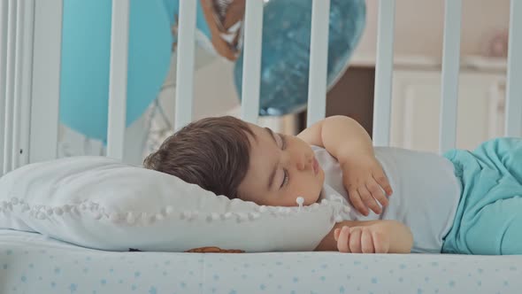 Baby Boy Sleeping In A White Children's Bed