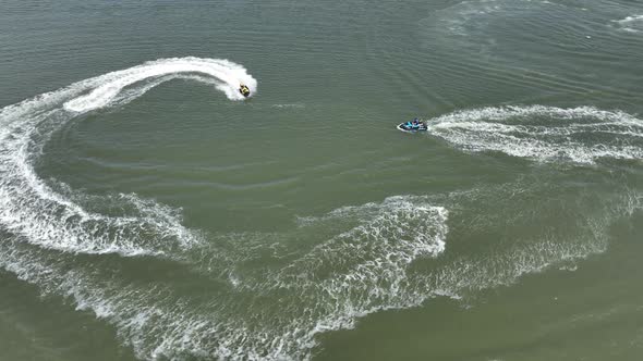 An aerial view over Gravesend Bay in Brooklyn, NY as two jet ski riders enjoys the beautiful day tog