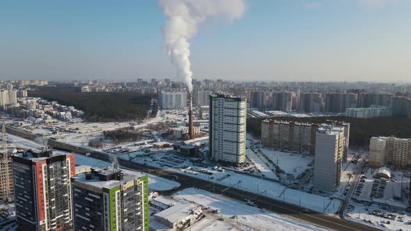 Aerial view on the winter city with smoke pipe