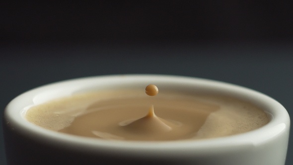 Coffee Drop falling into white ceramic mug