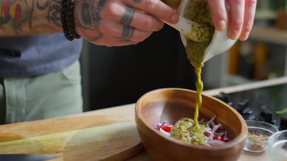 Adding Pesto Dressing to Salad