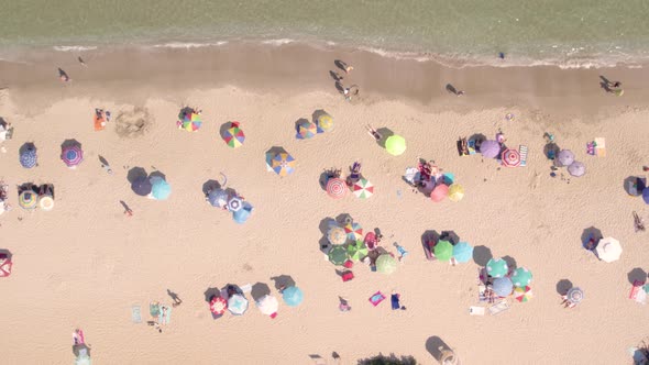 Aerial View of People Sunbathing on the Sea Beach at Hot Summer Day