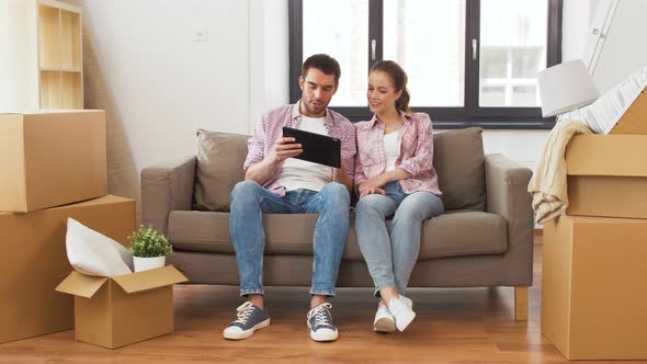 Happy Couple with Tablet Pc Computer at New Home