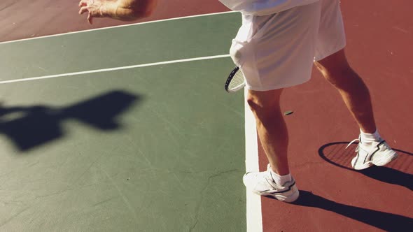 Man playing tennis on a sunny day