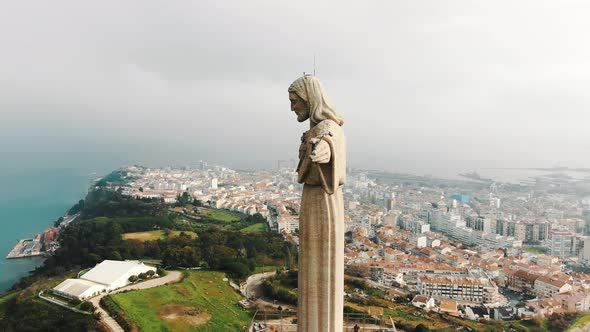 Majestic Jesus Stone Monument Against Almada City and Sky