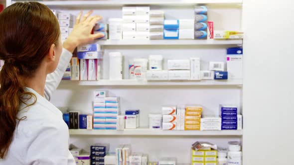 Pharmacist checking a medicine in pharmacy