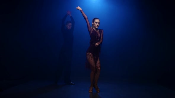 Tango Dancing Couple of Professional Elegant Dancers in Smoky Studio