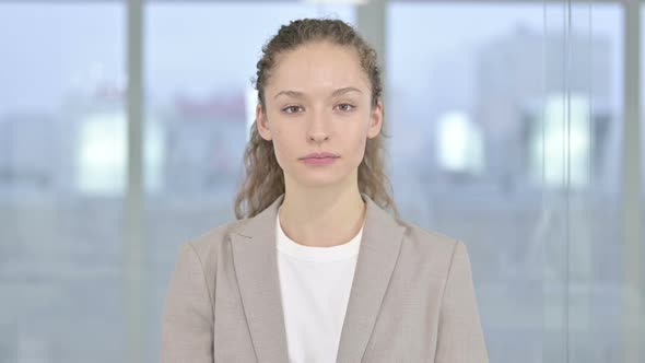 Portrait of Young Businesswoman Doing Thumbs Down