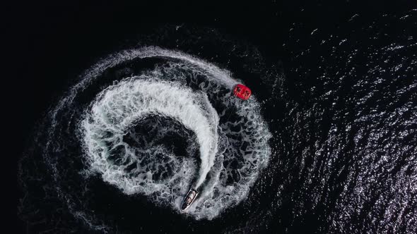 Happy People Swim on Air Mattress Behind a High Speed Water Bike