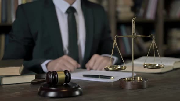 Close Up Shoot of Judge Hand Pointing Finger in Court Room Table