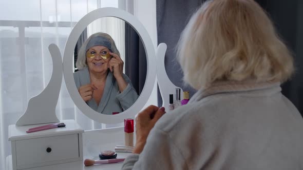 Old Senior Elderly Woman Grandmother Applying Anti-wrinkle Eye Patch, Putting Makeup on at Home