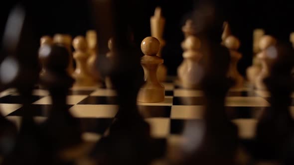 White and Black Wooden Pieces on a Chessboard