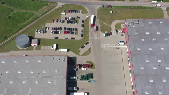 Aerial view of the logistics warehouse with trucks waiting for loading