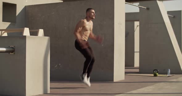 Male Athlete Running Outside Concrete Building