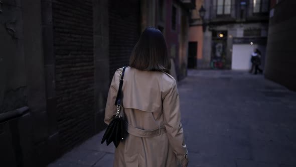 Back View of Woman Walking Alone in Barcelona Gothic Quarter