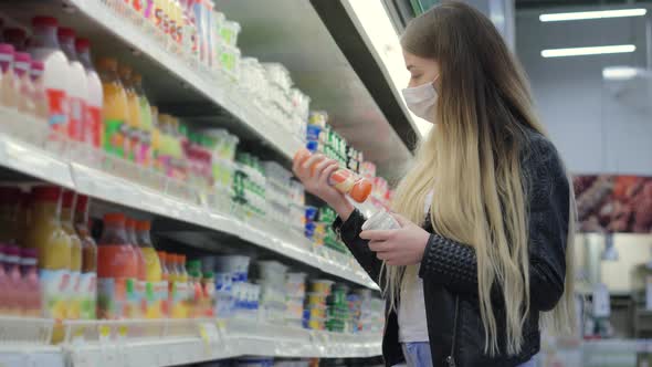 Young Lady in Medical Mask Buying Juice and Yogurt in Shopping Center