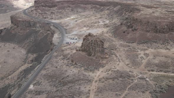 Dusty trails crisscross a weathered stone spire Frenchman's Coulee, Aerial orbit