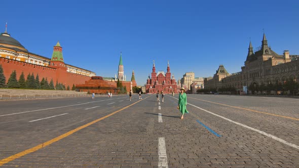 An attractive tourist walking along the Red Square