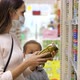 Young Woman with Child Girl in Medical Masks Buys a Canned Food at Supermarket - VideoHive Item for Sale