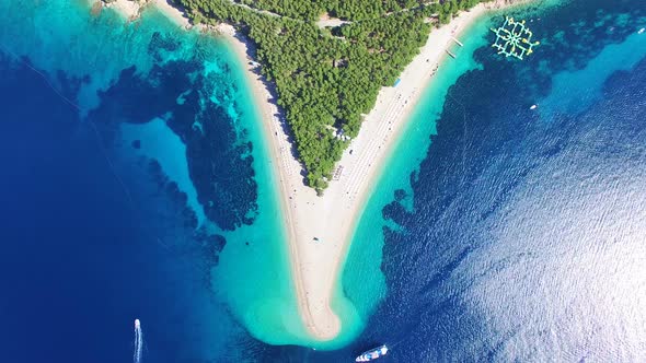 Aerial view of a boat passing sandy beach on the island of Brac, Croatia