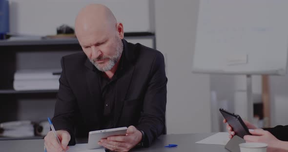 Businessman with Tablet PC Working in Office