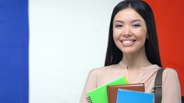 Smiling Student With Copybooks, French Flag Background, Education in France