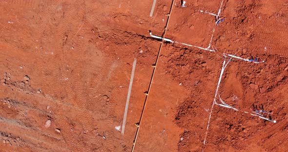 Laying Water PVC Plastic Pipes in Ground During Plumbing Construction Site