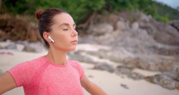 Woman on Yoga Mat Meditating on the Beach She Makes Breath Exercise Before the Sun Set