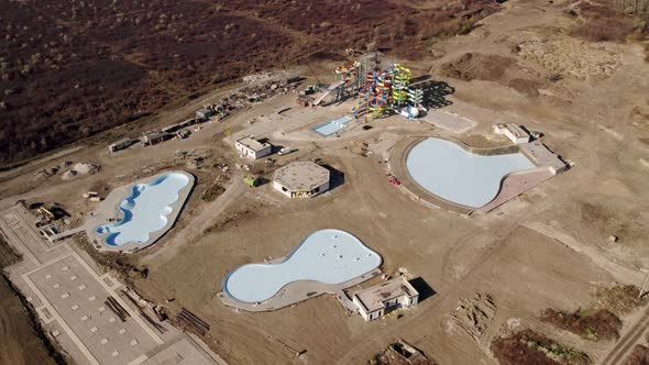 Aquapark Under Construction on a Large Sand Construction Site with Fun Tracks