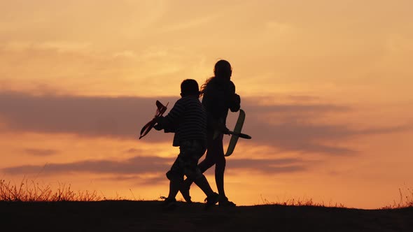 Happy Children Play Pilots, Run with Toy Planes in Their Hands