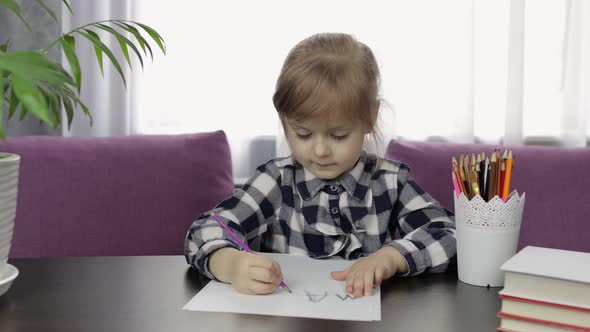 Cute Child Girl Studying Drawing Picture with Pencil at Home. Distance Education