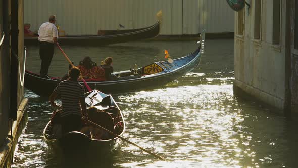 Heavy movement of gondolas with tourists, water traffic laws in Venice, Italy