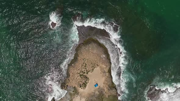 Ocean waves breaking on a rocky shore, Aerial view.