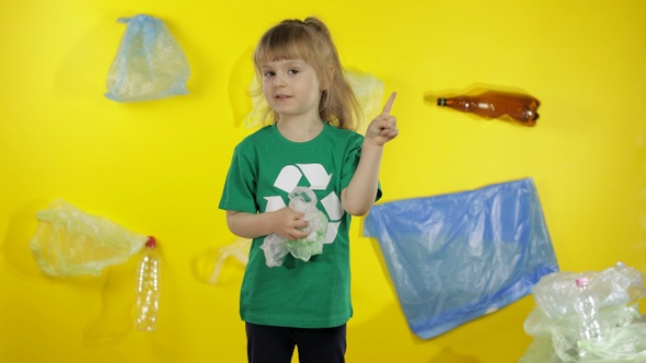 Girl Activist Volunteer in Green T-shirt with Recycle Logo. Plastic Pollution
