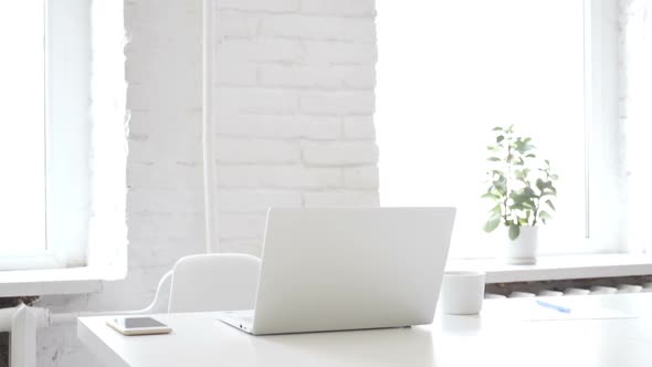 Empty Creative Office with Laptop on Desk