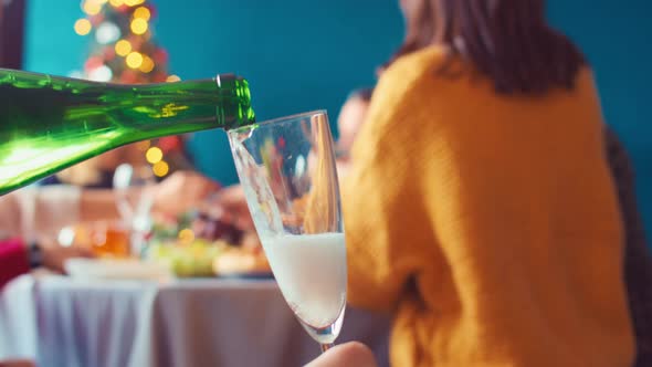 Pouring Champagne Into Glass Background Christmas Table Where People Communicate Eat