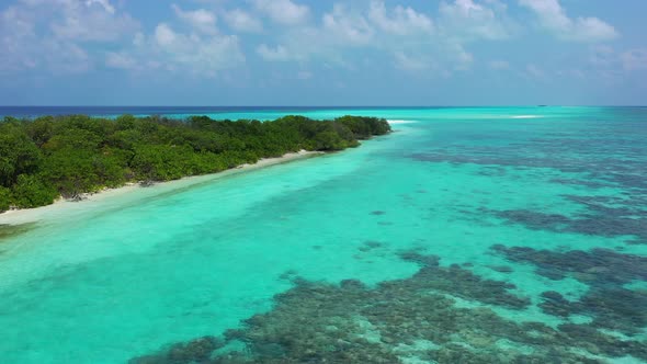 Wide overhead tourism shot of a white paradise beach and turquoise sea background in high resolution