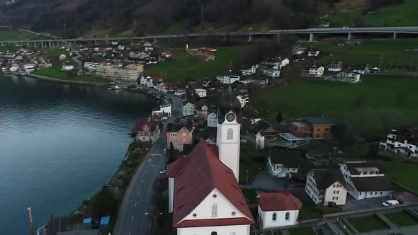 Aerial video of traditional Swiss village along Lake Lucerne, Switzerland.