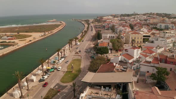 Establishing Aerial Drone View of Lagos City By Sea Algarve Portugal Downtown Cityscape Tilt Down to