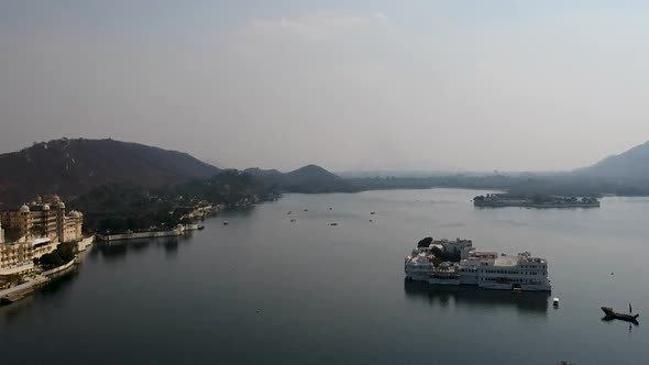 Aerial establishing shot of Lake Pichola including Taj lake palace, Udaipur, Rajasthan, India