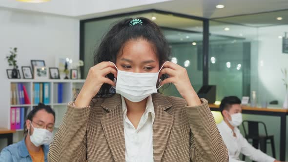 Portrait of young office businesspeople wear face mask working indoor with new normal lifestyle.