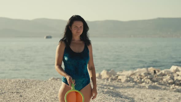 Timelapse Video of a Girl in a Swimsuit Playing Tennis on the Beach