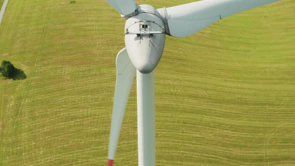 Zoom Out of Camera From a Propeller of the Windmill in the Field with Mountains on the Background