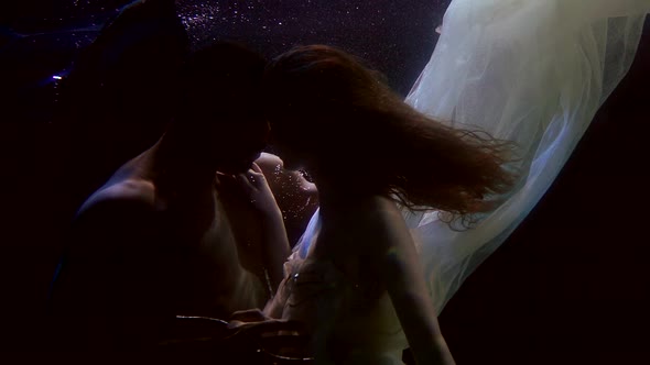 Passionate and Sensual Embrace of Loving Pair Underwater, Man and Woman Are Caressing