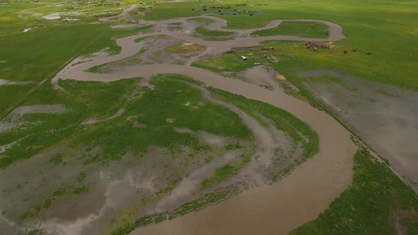 Aerial view of river winding through landscape as it floods