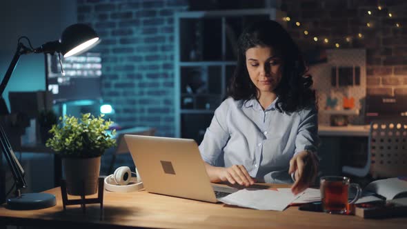 Tired Girl Working at Night in Office Reading Documents Suffering From Headache