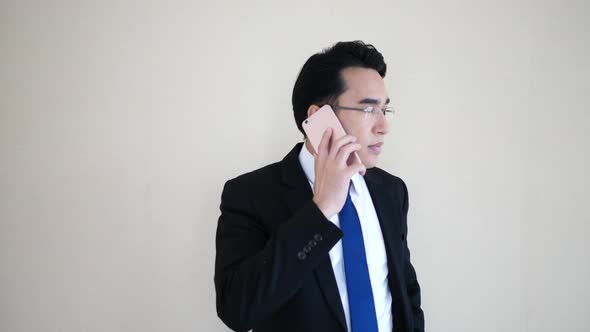 Asian young businessman talking at phone.