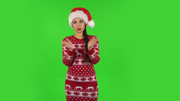 Sweety Girl in Santa Claus Hat Is Clapping Her Hands Indifferent. Green Screen